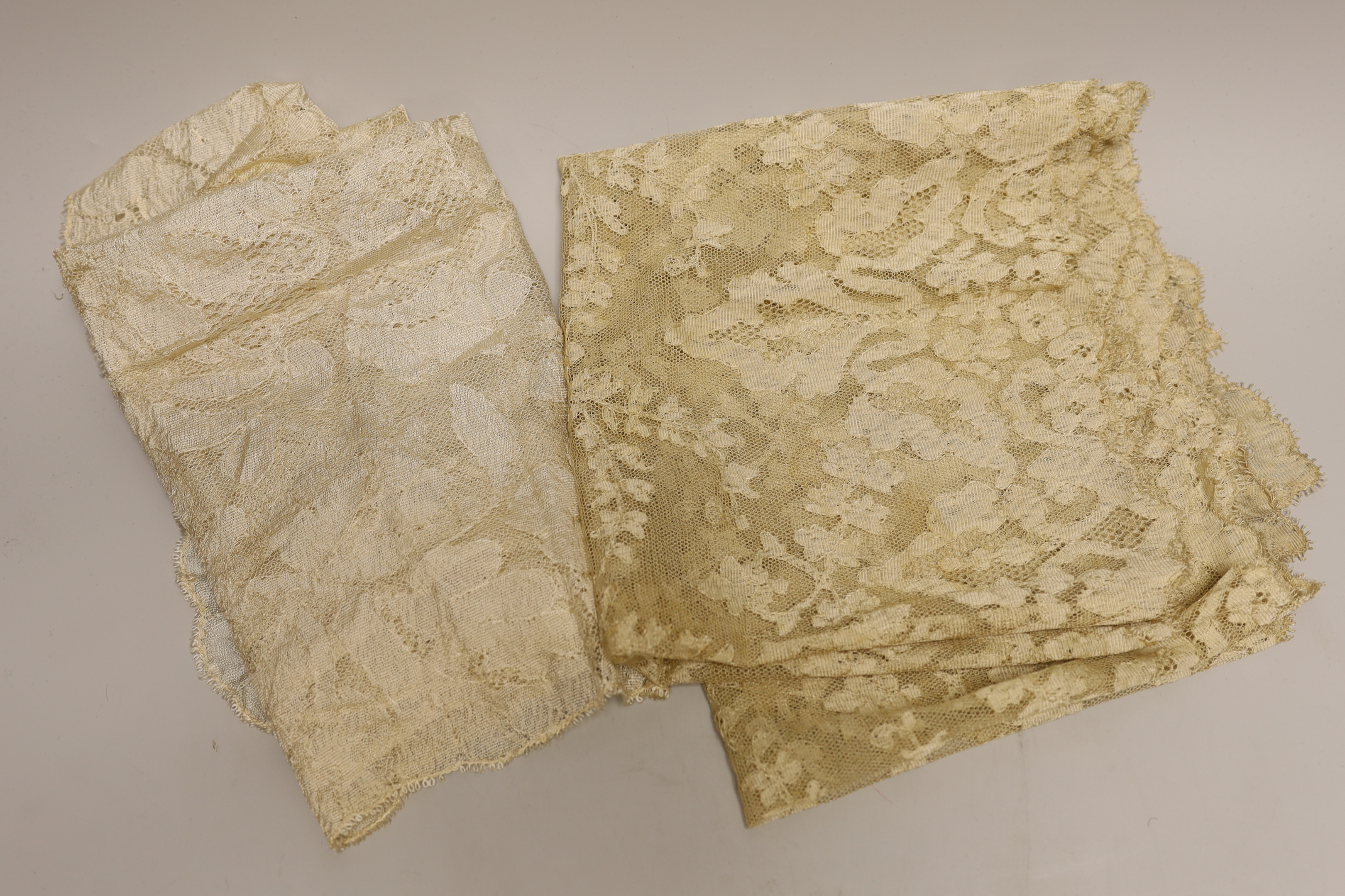 An Irish needle run 19th century lace veil, a machine lace ‘Blonde’ veil and two later cream silk lace stoles